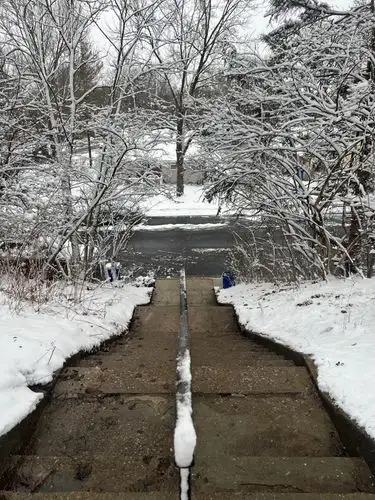Snowy steps leading to a tranquil winter scene.